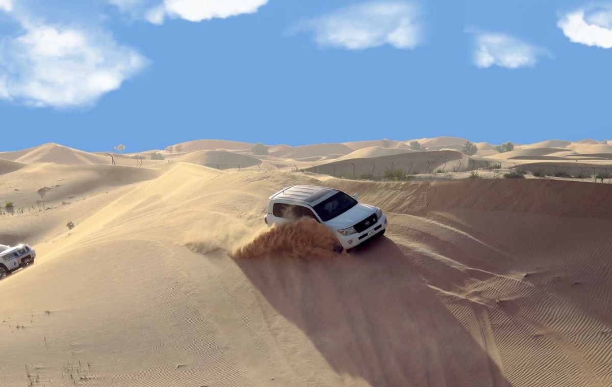 Tourists enjoying Liwa Overnight Desert Safari with epic dunes view